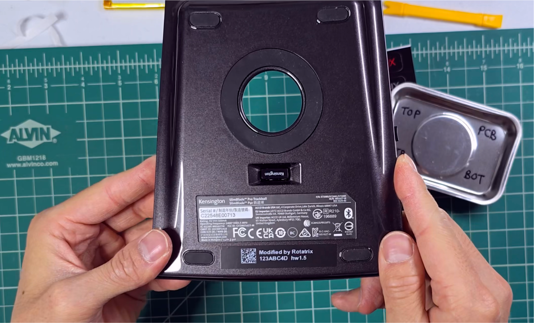 The Rotatrix serial label applied to the bottom of the device, centered under the Kensington device label